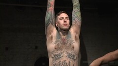 Tattooed gay stud gets tied up in the dungeon Thumb