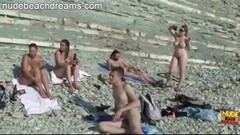 A bunch of naked people relaxing at the beach Thumb